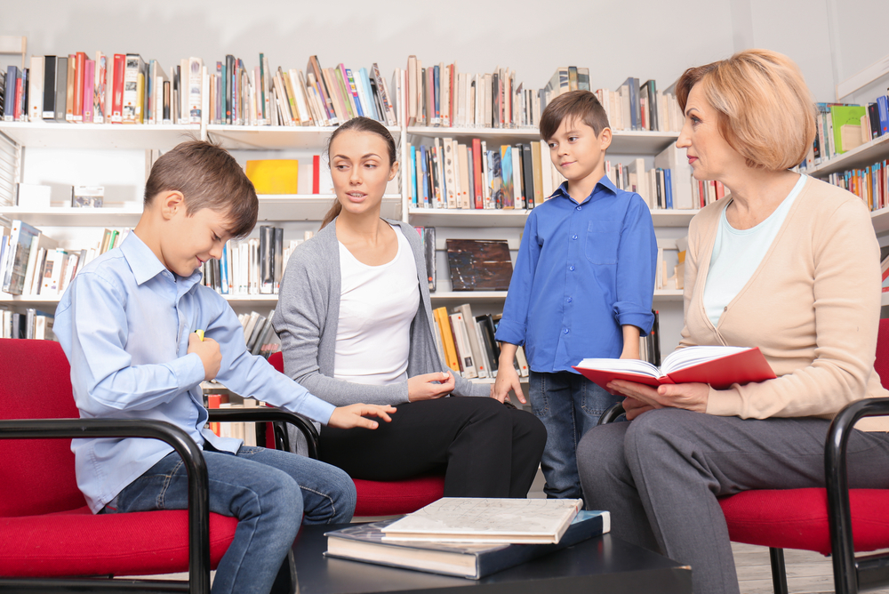 A mother meets with her sons' teacher