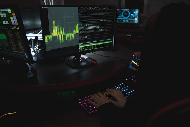 Photo of someone using a computer to perform a cyberattack.